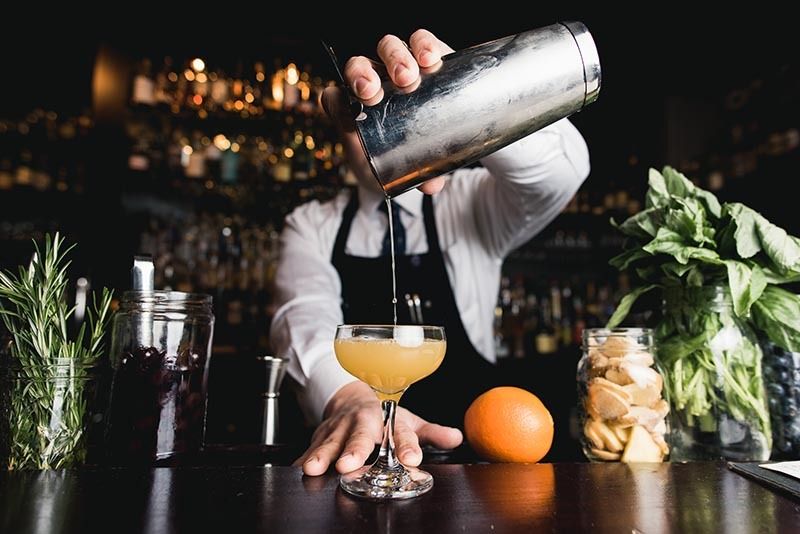 Bartender pouring craft cocktail