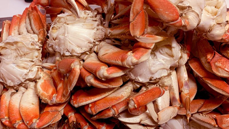 a pile of cleaned and cracked dungeness crab ready to eat