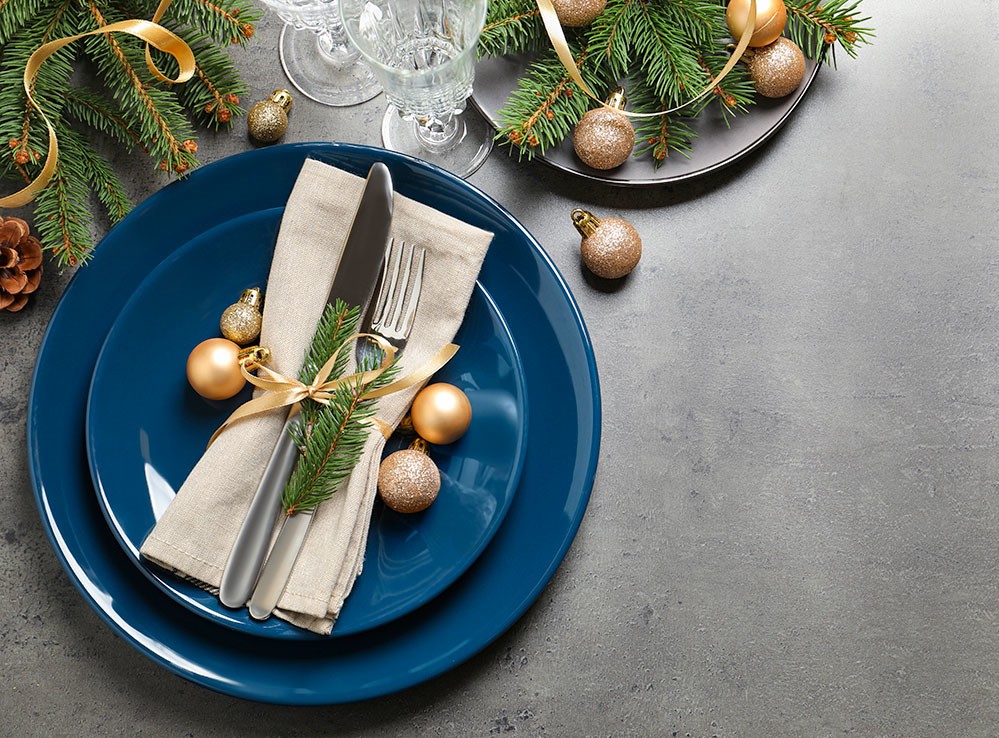 Festive table setting with beautiful dishware and Christmas decor for Christmas Eve dinner